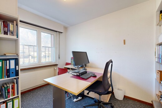 office with dark carpet and baseboards