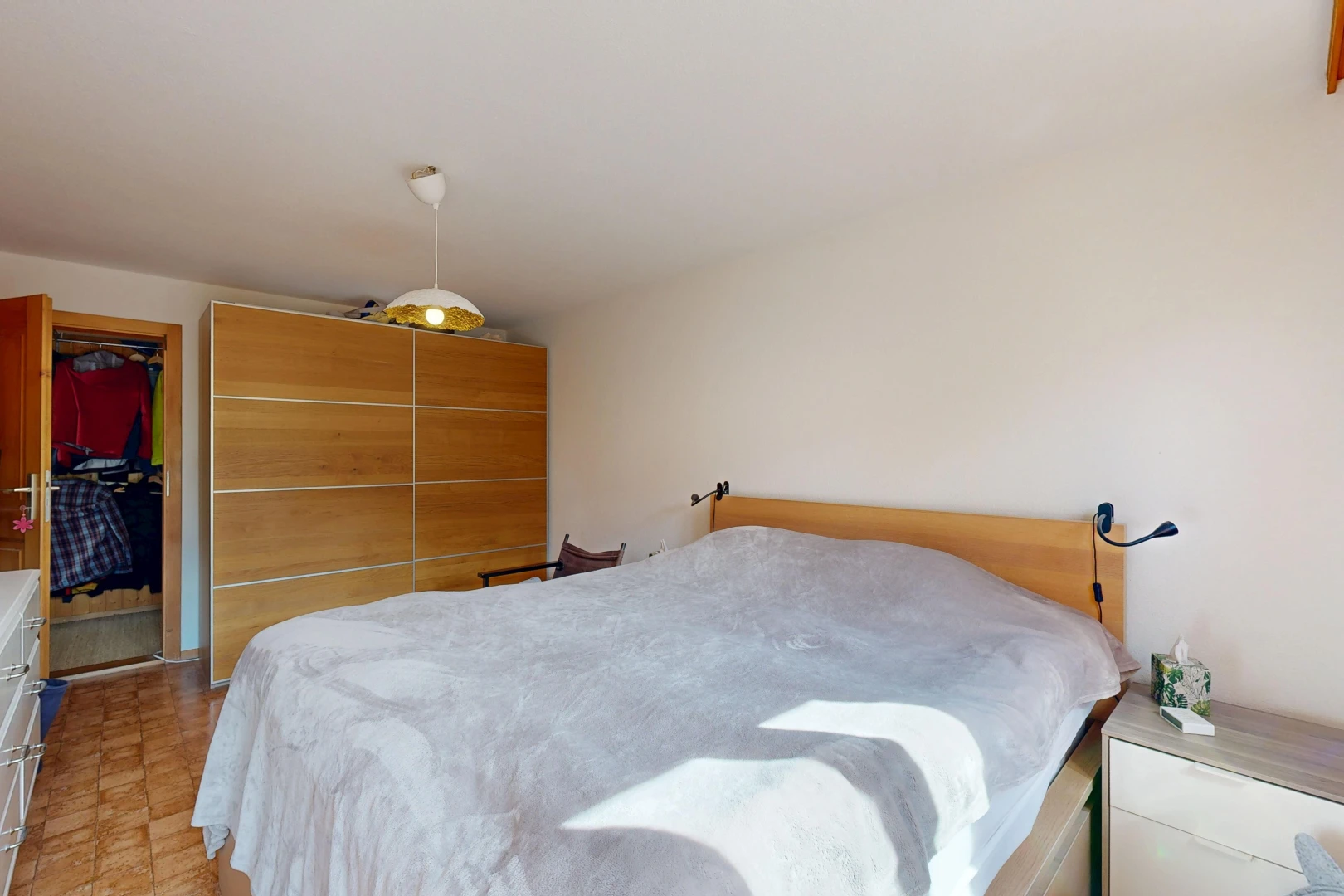 room with a closet and decorative light fixtures
