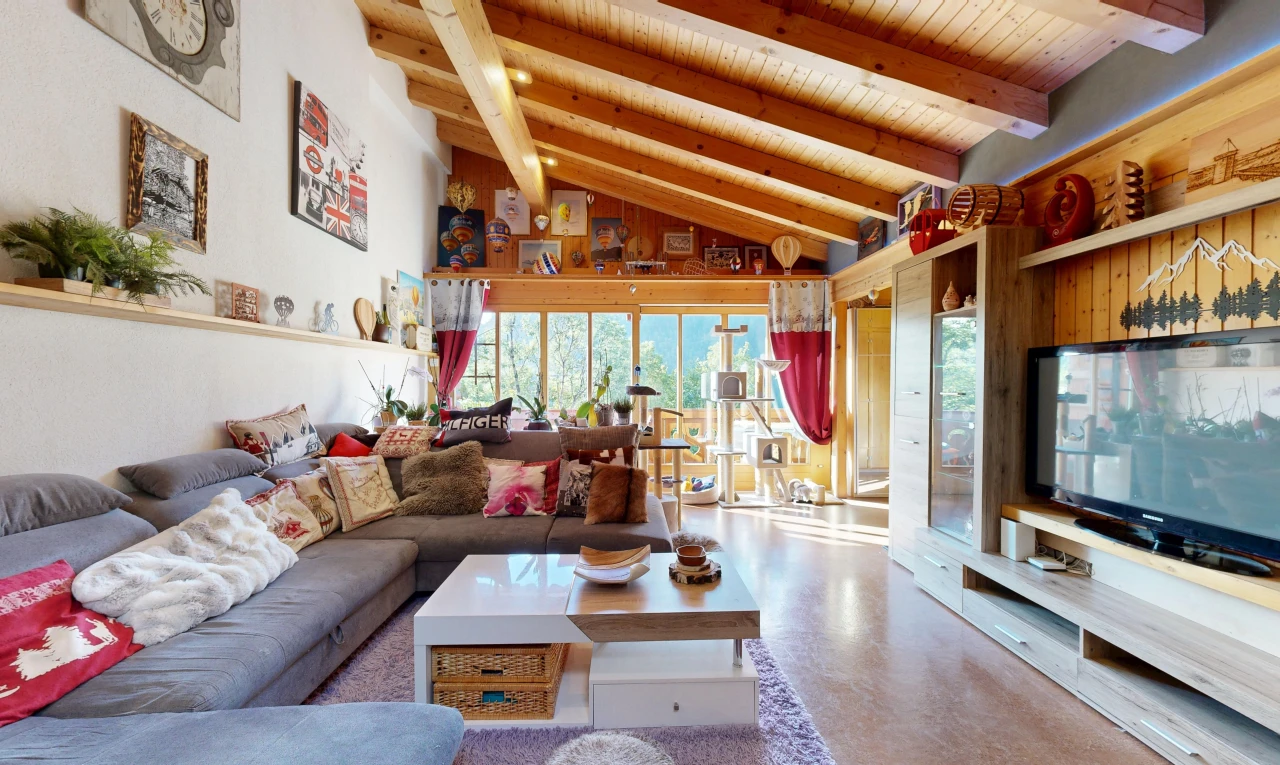 living room with a high wood beamed ceiling, built in shelves, and concrete flooring