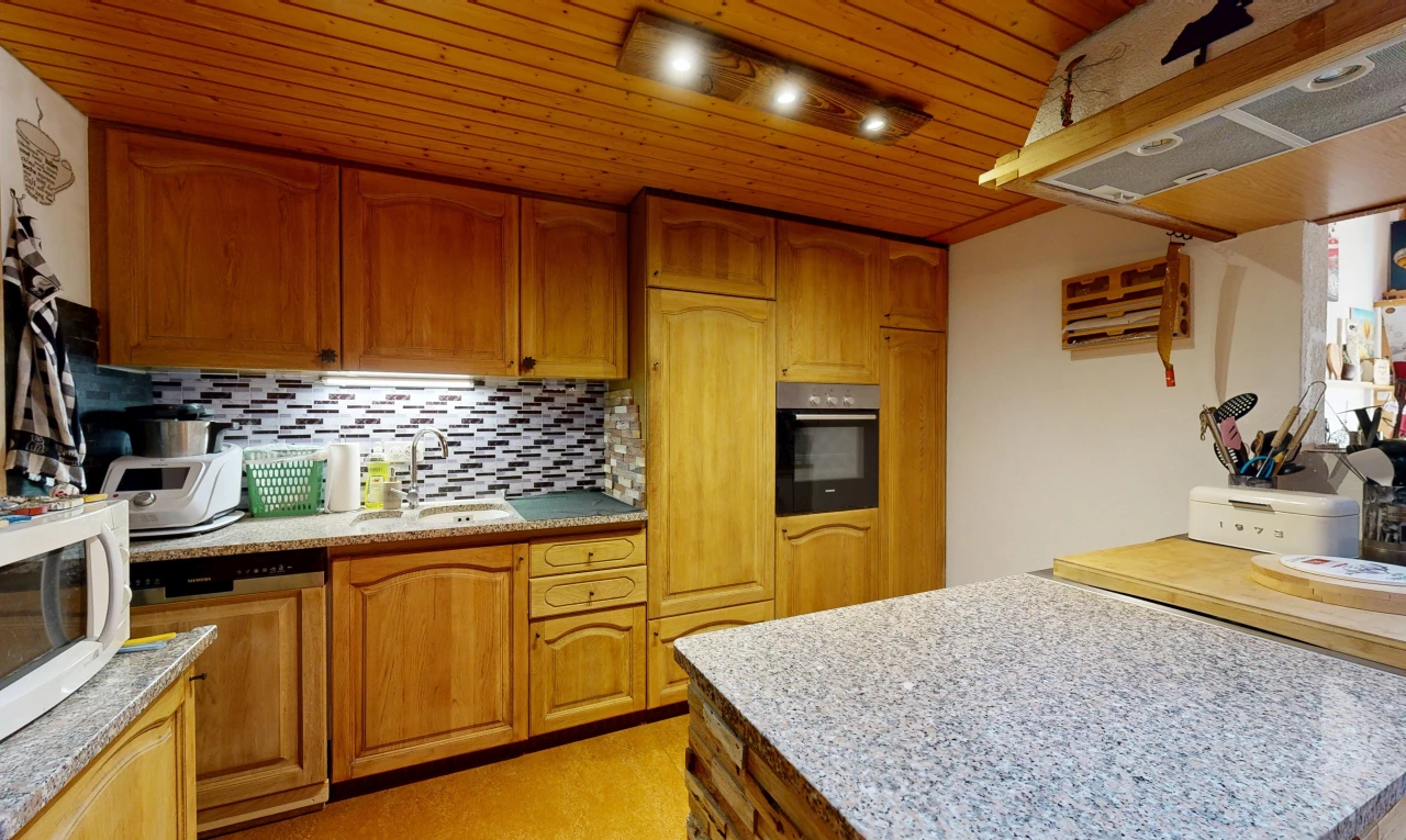 kitchen with wood ceiling, paneled dishwasher, light stone countertops, wood finish cabinets, and tasteful backsplash