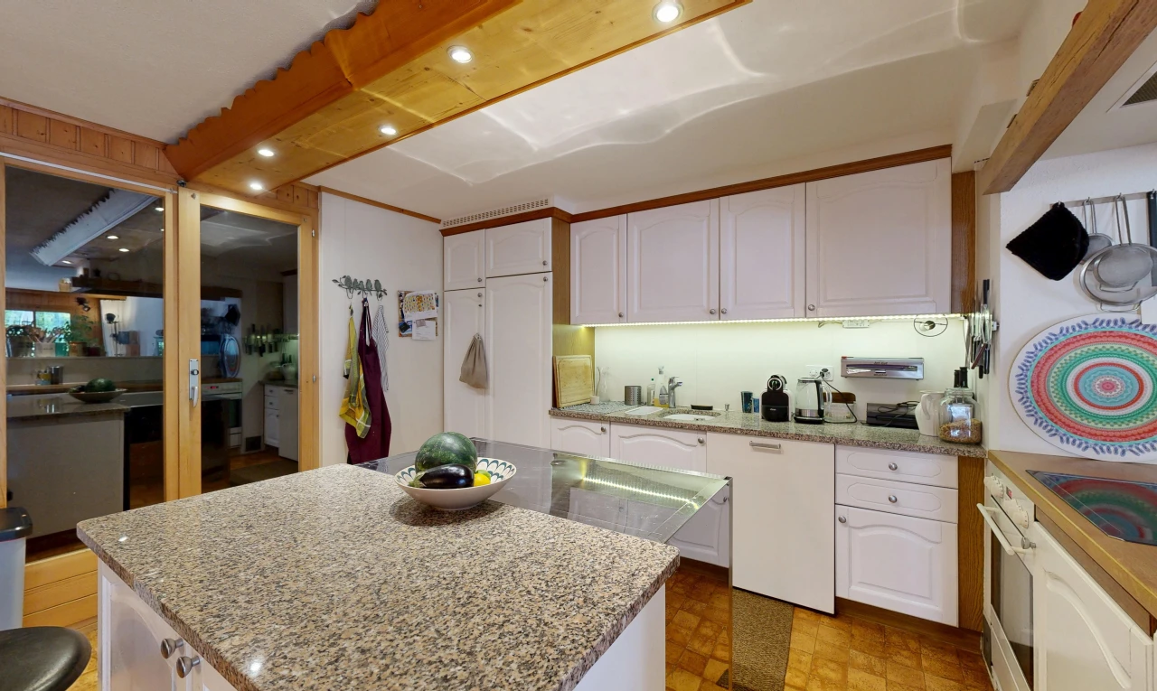 kitchen featuring white cabinetry and light stone countertops