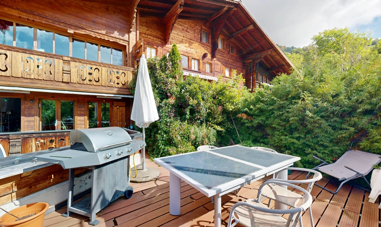 view of wooden deck with outdoor dining space and grilling area