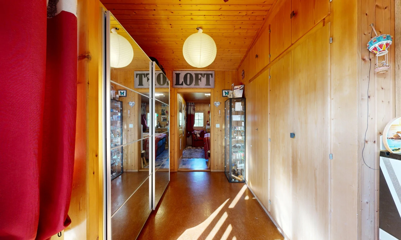hall with wood ceiling and wooden walls