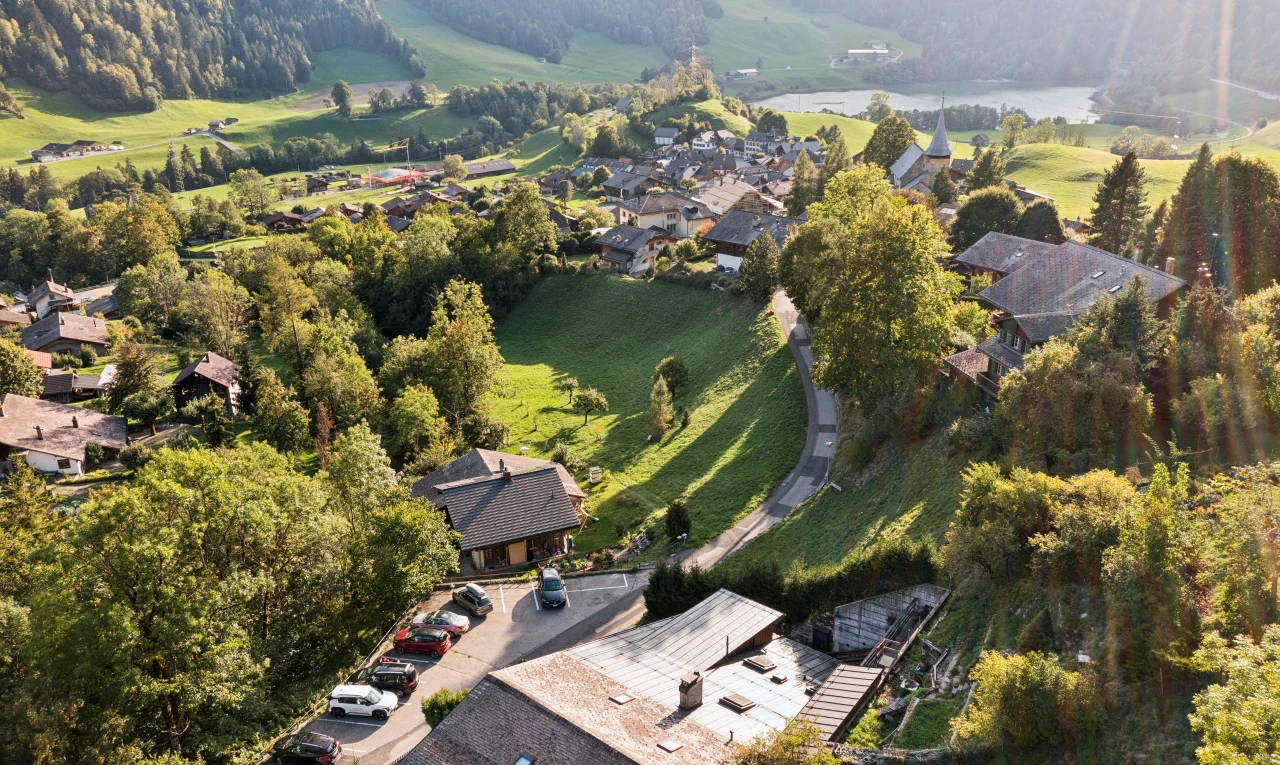 view of mountain backdrop with a nearby body of water and nearby suburban area