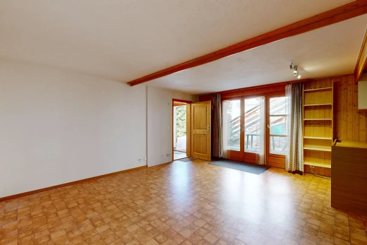 unfurnished room featuring rail lighting, built in shelves, access to outside, beamed ceiling, and light flooring