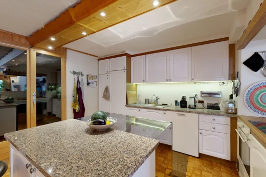 kitchen featuring white cabinetry and light stone countertops