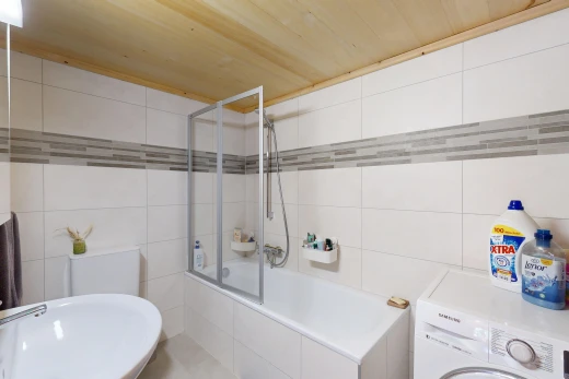 full bathroom with tile walls, washer / clothes dryer, and tiled shower / bath