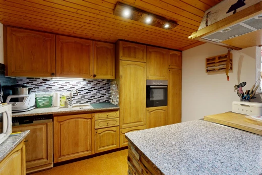 kitchen with wood ceiling, paneled dishwasher, light stone countertops, wood finish cabinets, and tasteful backsplash