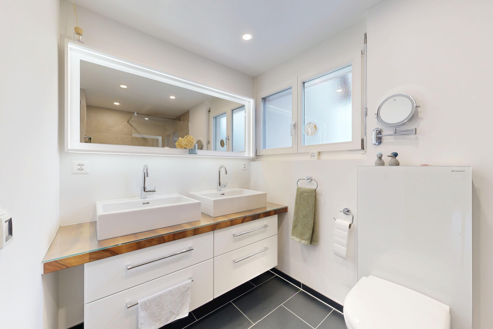 bathroom with double vanity, dark tile patterned floors, a shower, and recessed lighting