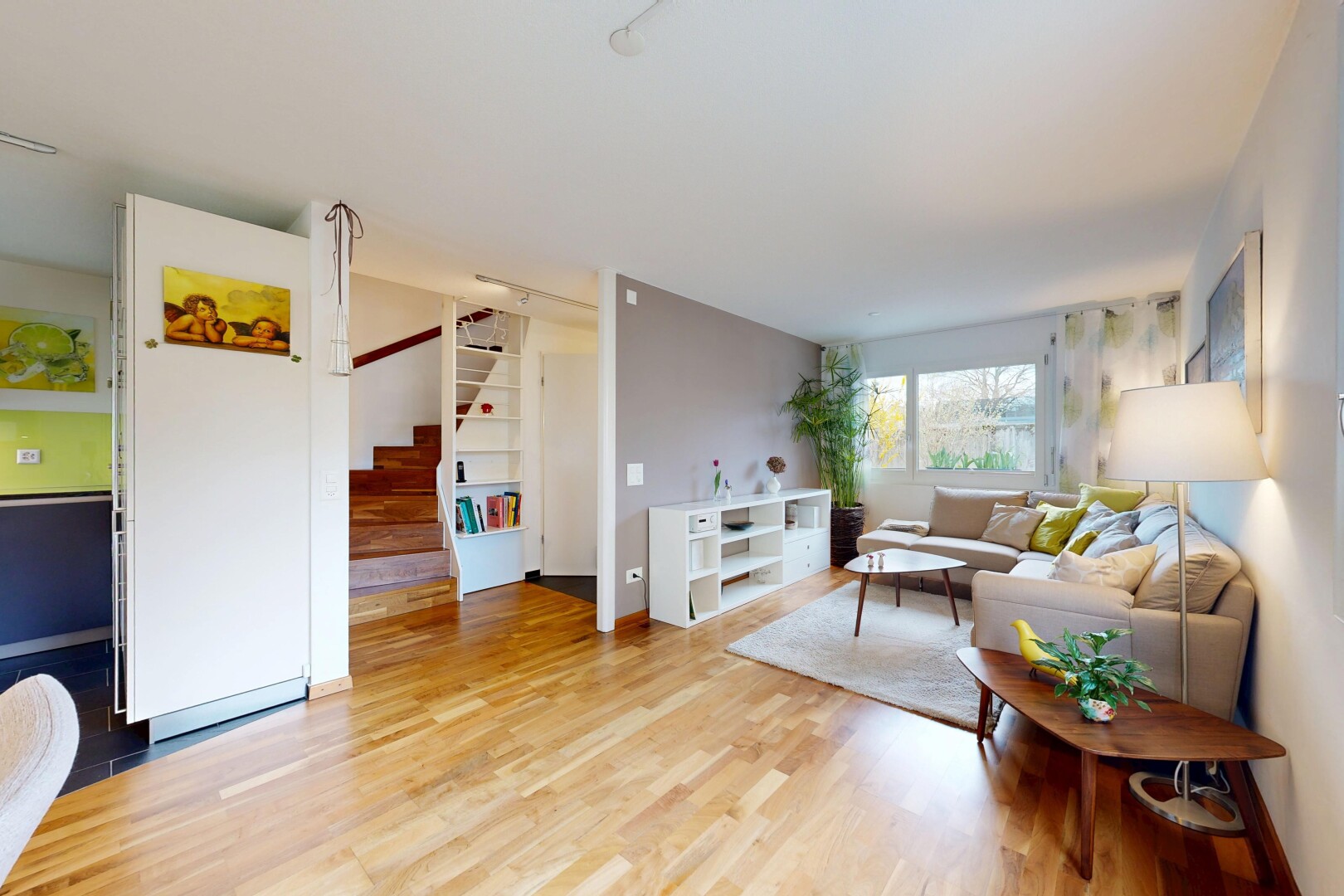 living area featuring stairs and light wood-style floors