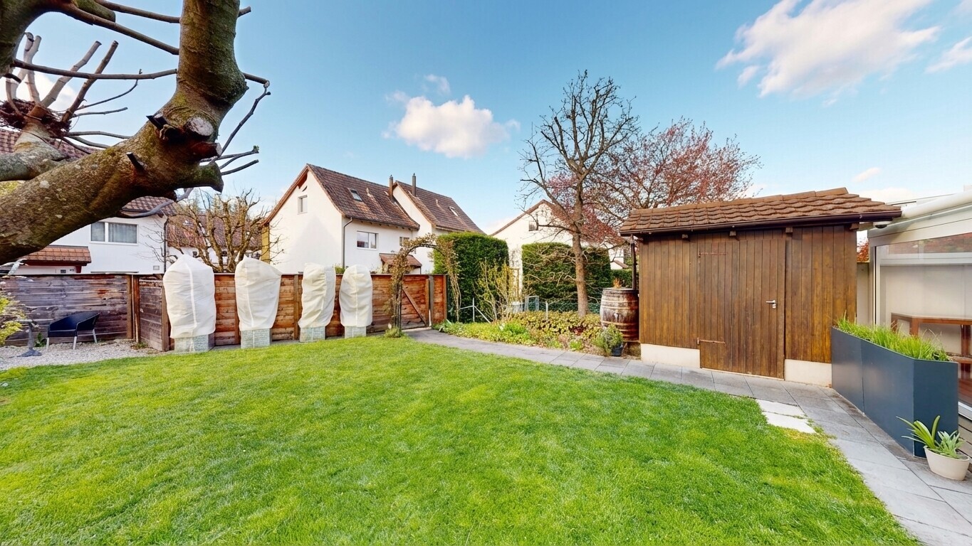 outdoor house with a gate and a storage unit