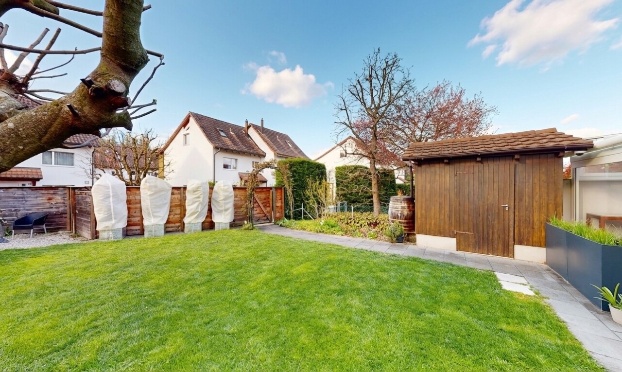 outdoor house with a gate and a storage unit