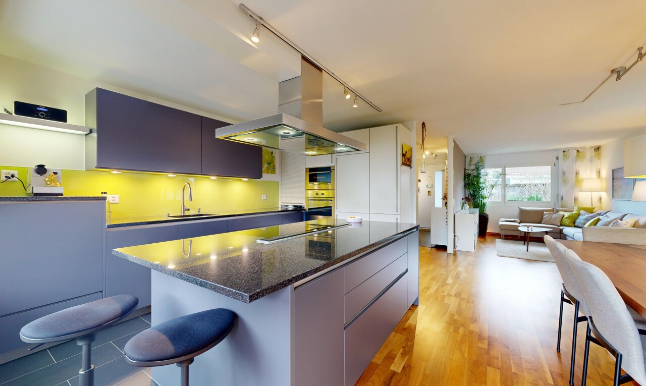 kitchen featuring a breakfast bar, a kitchen island, track lighting, modern cabinets, and light wood-type flooring