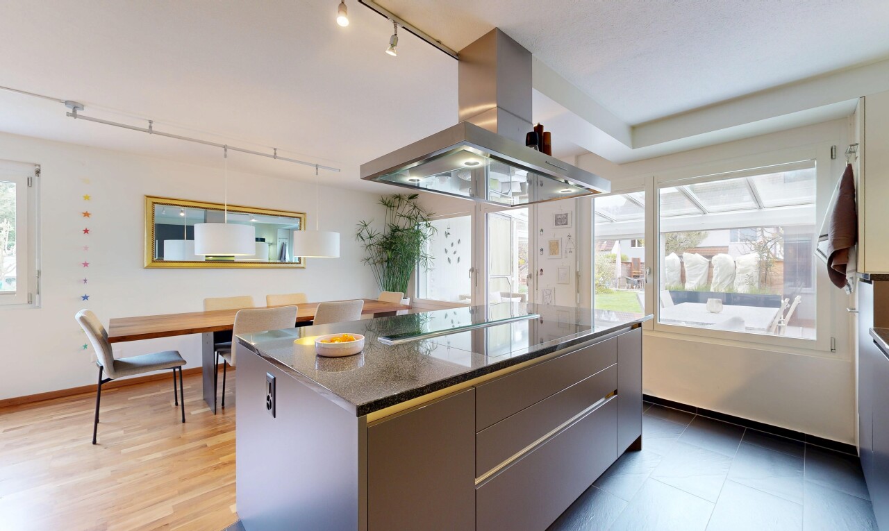 kitchen featuring island range hood, modern cabinets, rail lighting, a kitchen island, and dark stone countertops