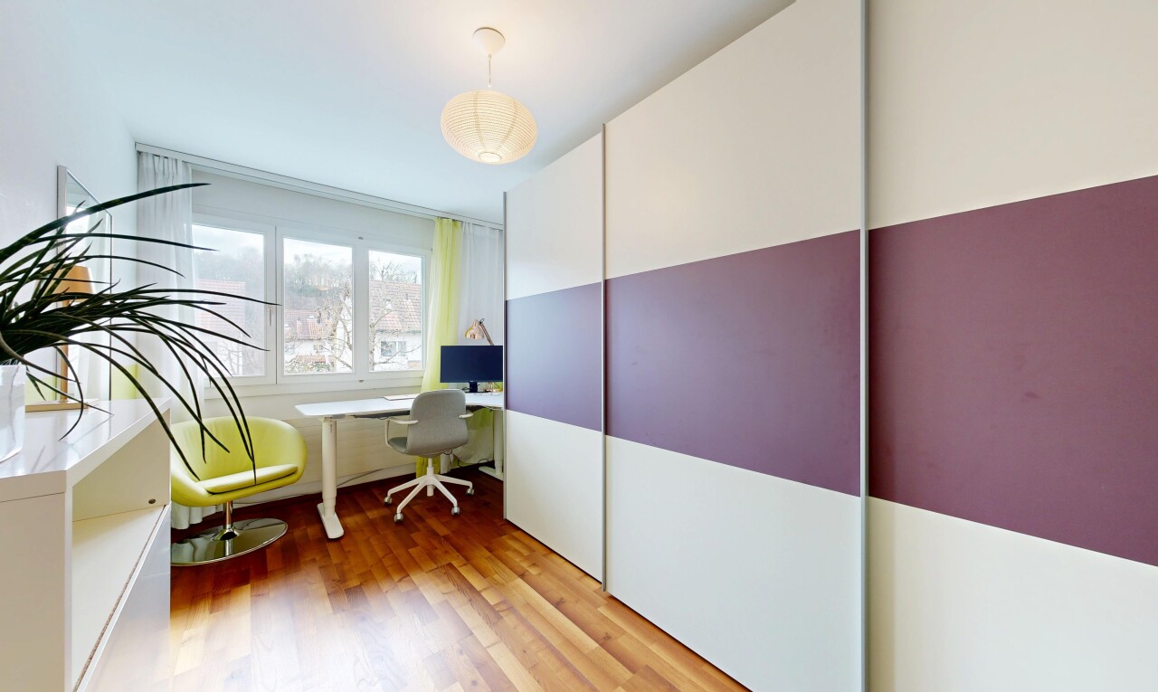 room with an office area and light wood finished floors