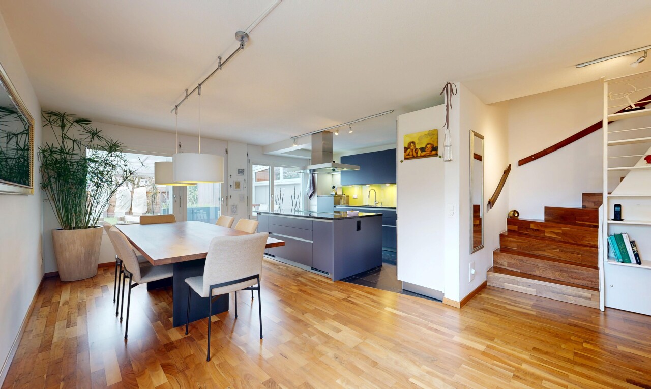 dining space with rail lighting and light wood-style flooring