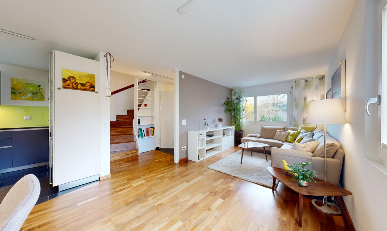 living area featuring stairs and light wood-style floors