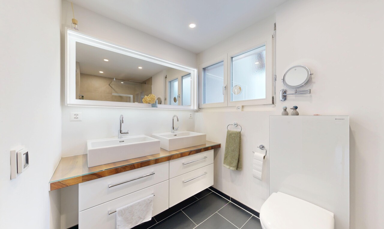 bathroom with double vanity, dark tile patterned floors, a shower, and recessed lighting
