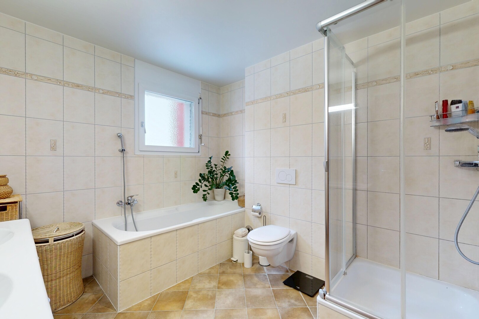 bathroom featuring tile walls, a shower stall, vanity, light tile patterned flooring, and tiled tub