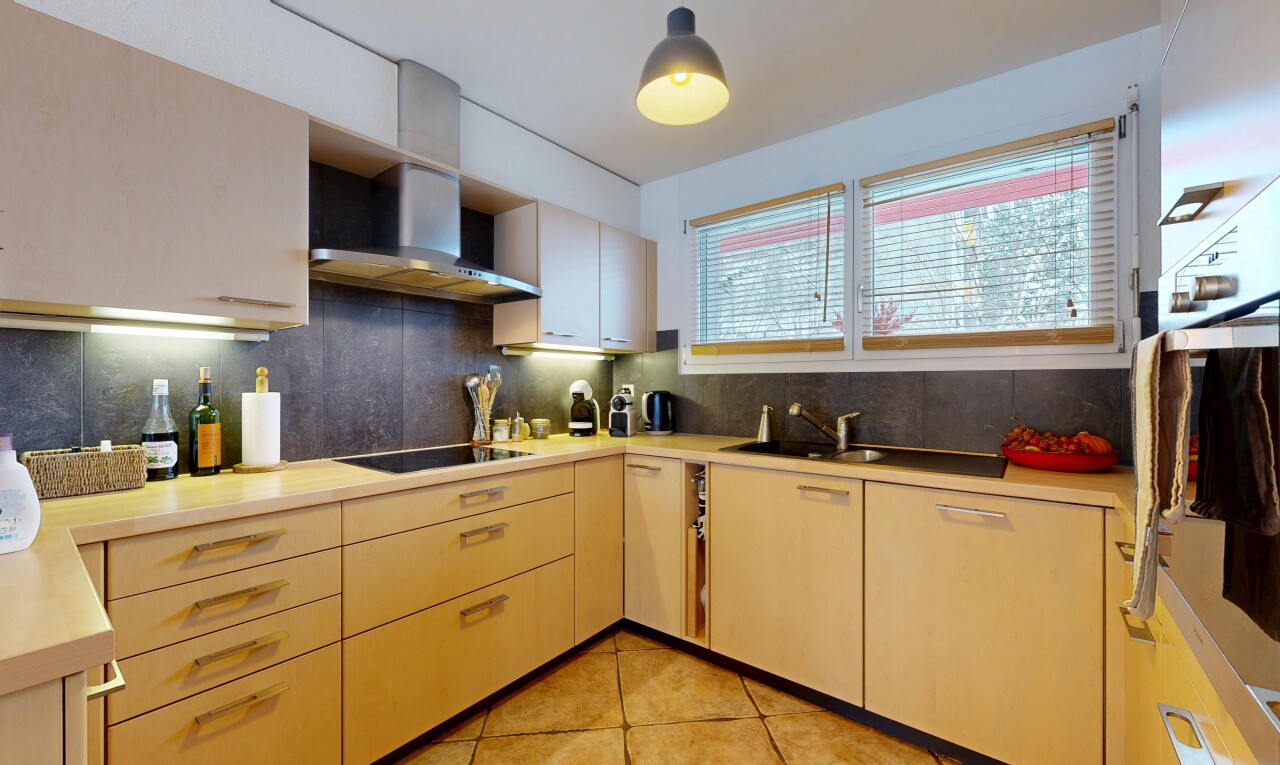kitchen with backsplash, light countertops, wall chimney exhaust hood, light tile patterned floors, and oven