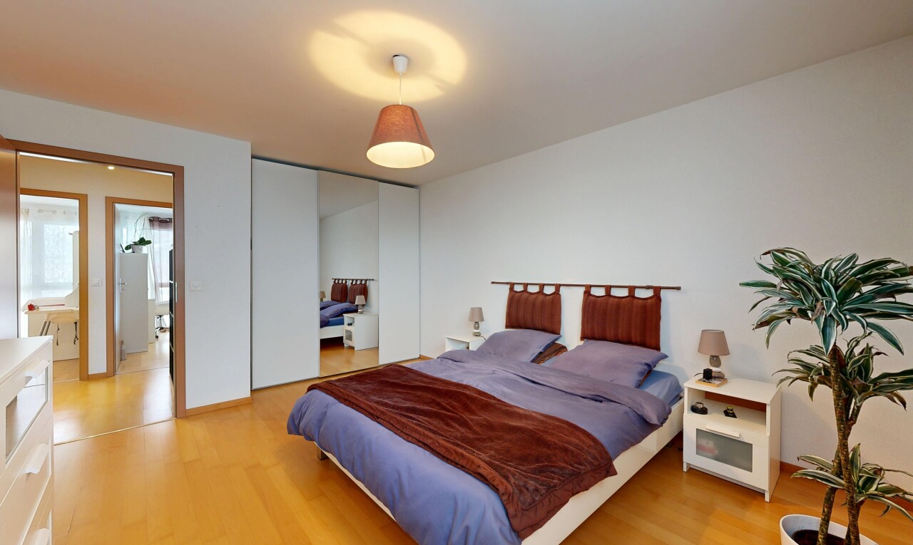room / bedroom featuring a closet and light wood-style floors