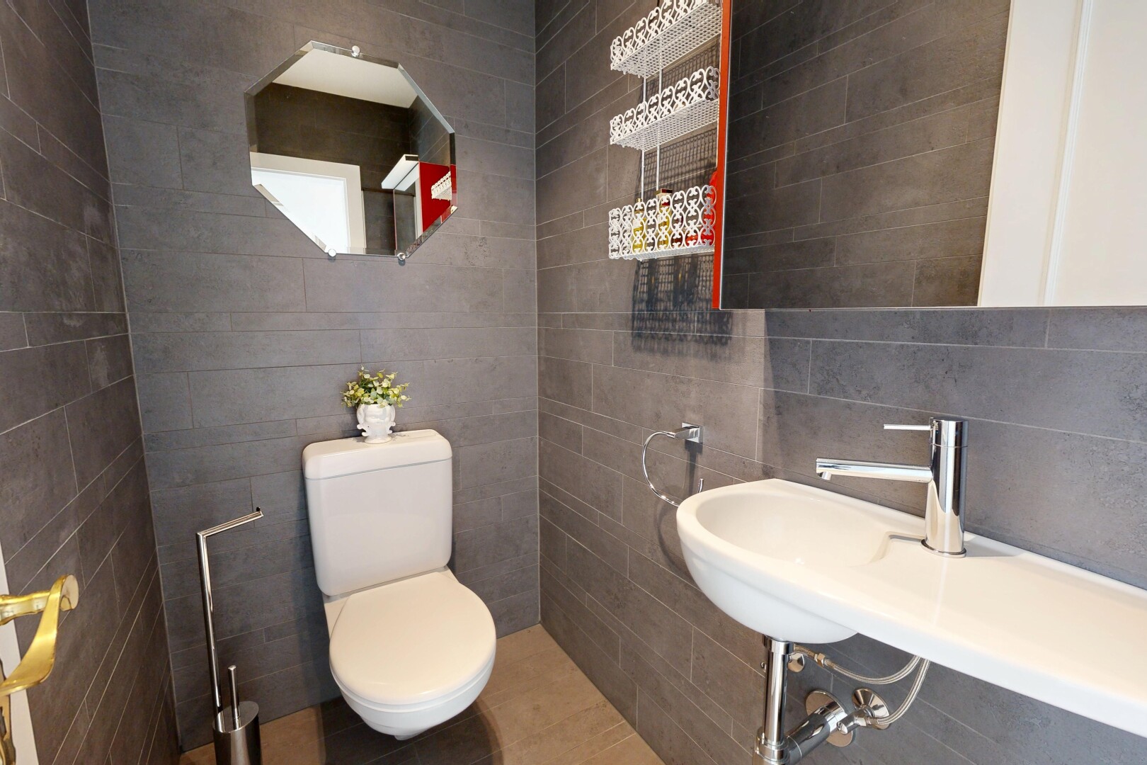 bathroom with toilet and tile walls
