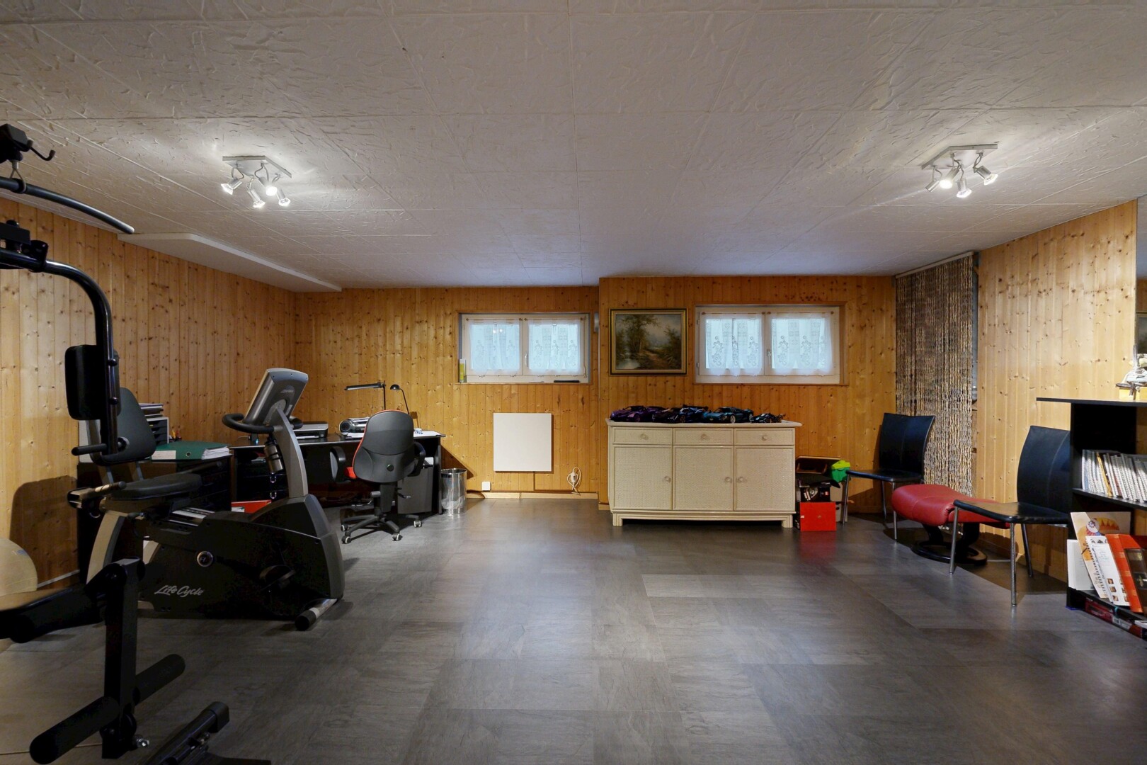 workout area with wooden walls and dark rubber floors