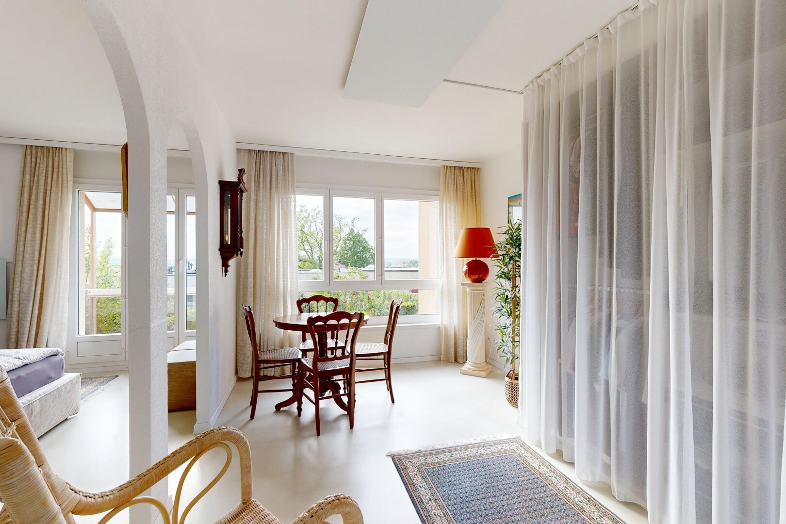 living / dining area featuring arched walkways