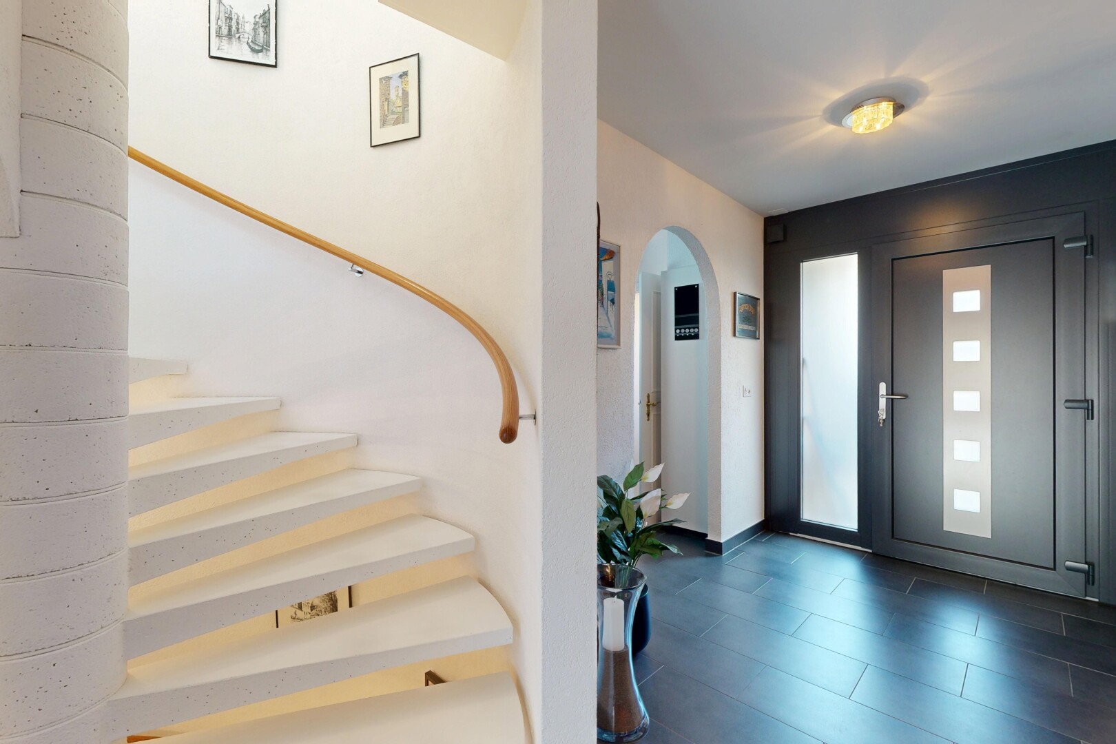stairway featuring arched walkways