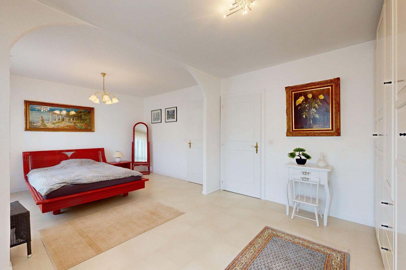 room / bedroom featuring arched walkways, a chandelier, and light flooring