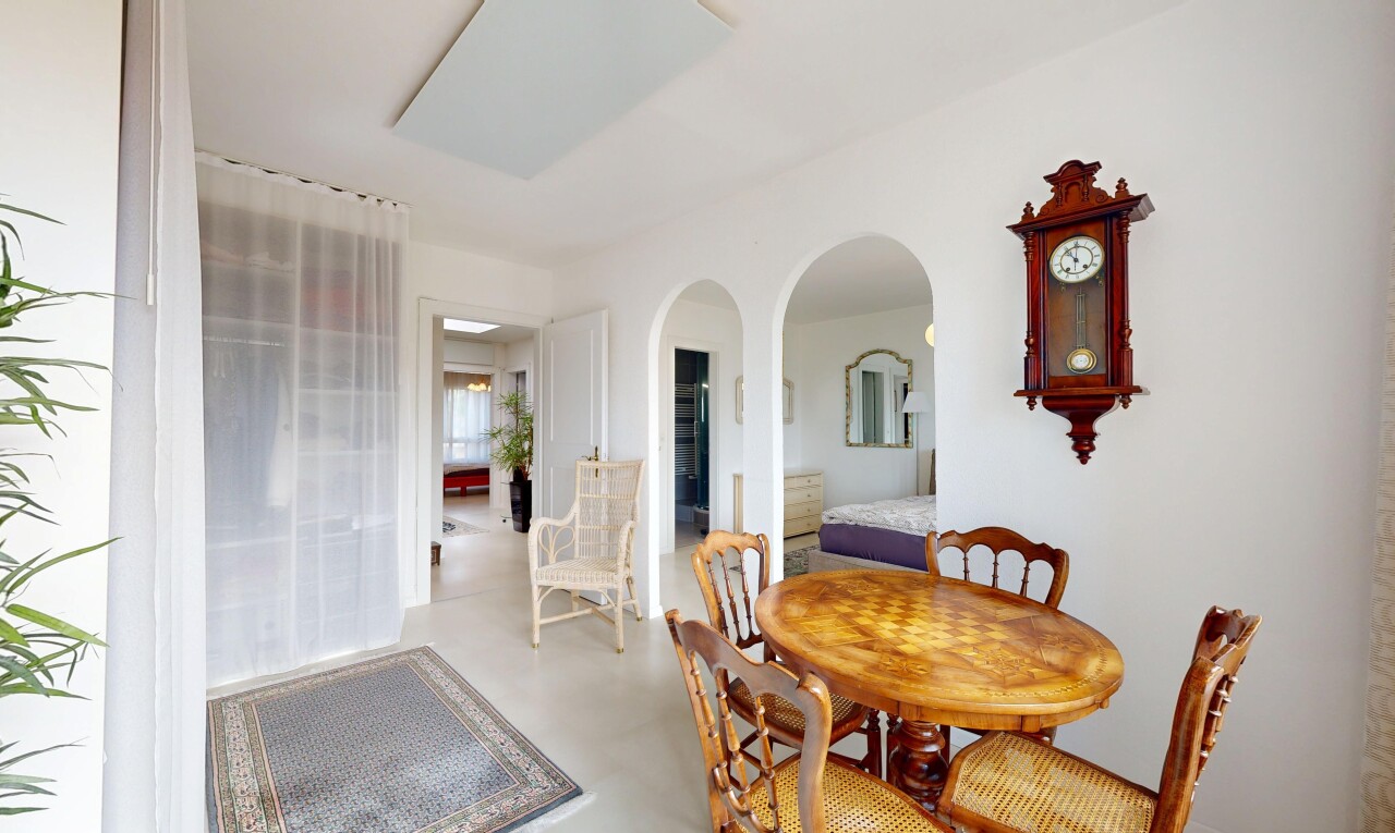 dining area with arched walkways and finished concrete flooring