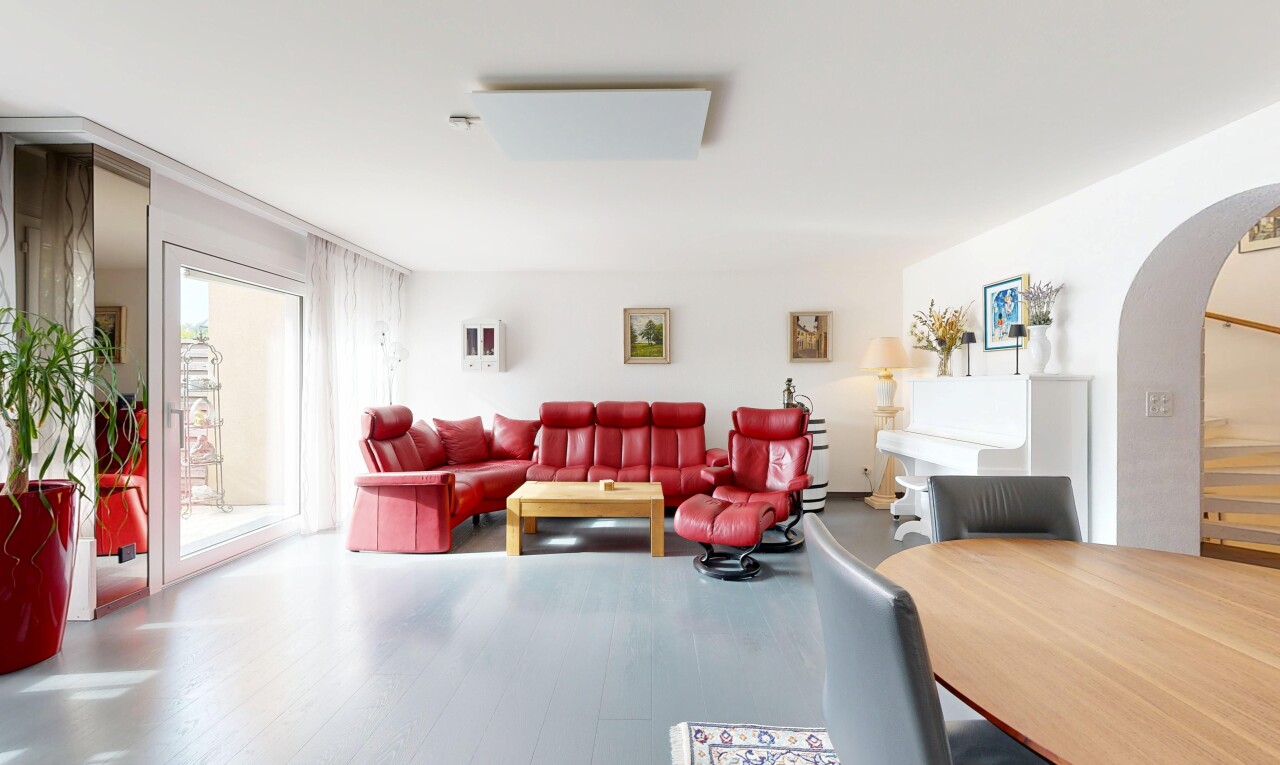 living area with arched walkways and wood finished floors