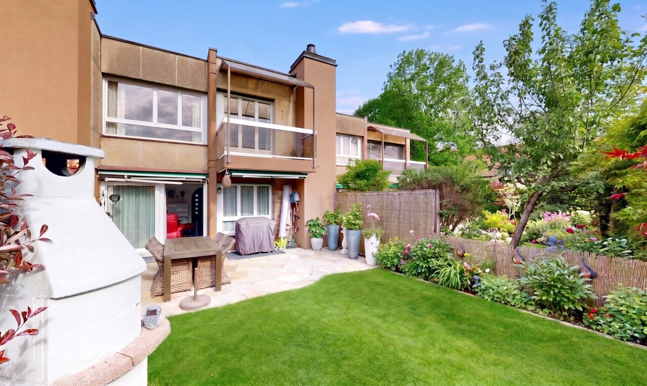 view of property with stucco siding, a chimney, a balcony, and a patio area