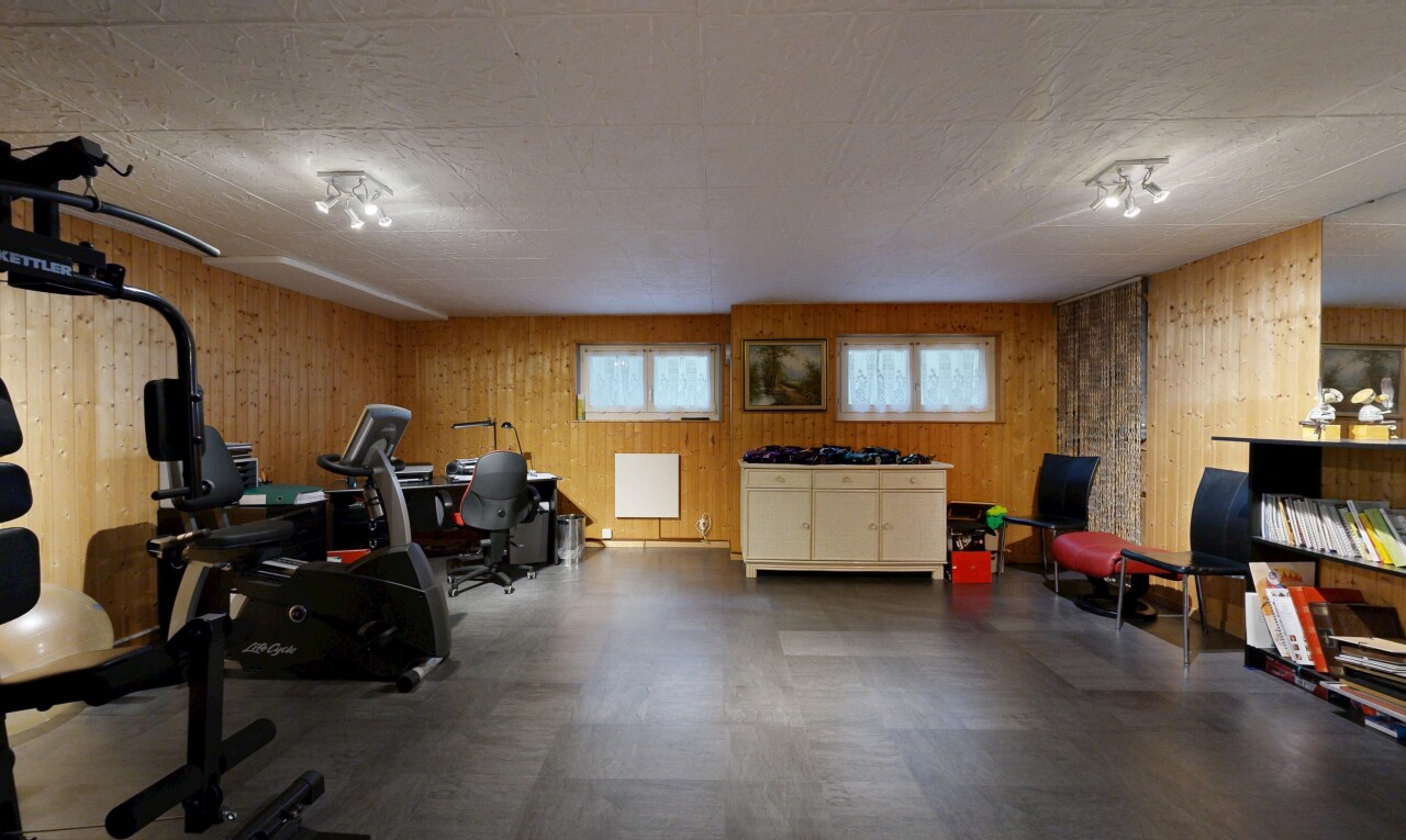 workout area with wooden walls and dark rubber floors