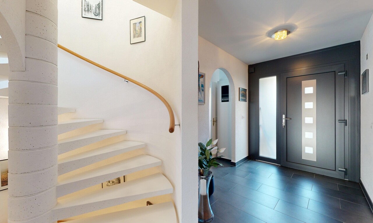 stairway featuring arched walkways