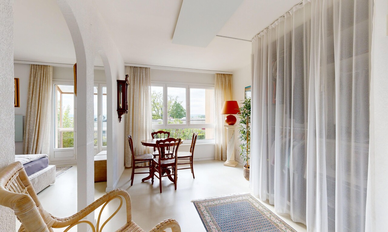 living / dining area featuring arched walkways