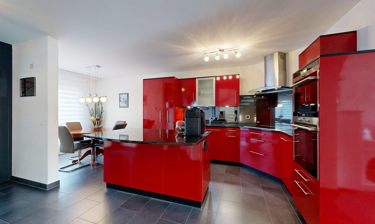 kitchen featuring red cabinets, range hood, and modern cabinets
