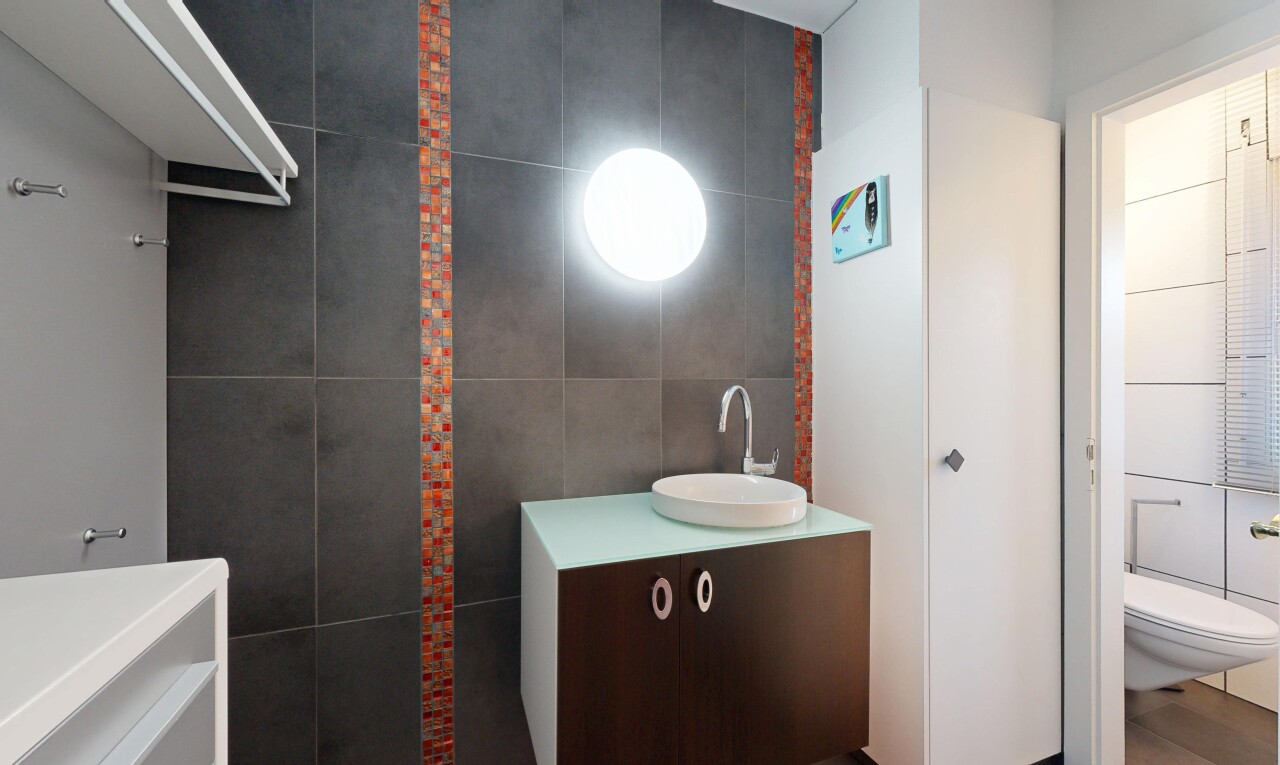 bathroom featuring tile walls and vanity