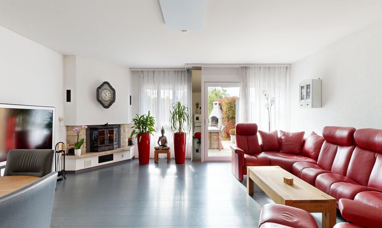 living area featuring a glass covered fireplace and wood finished floors