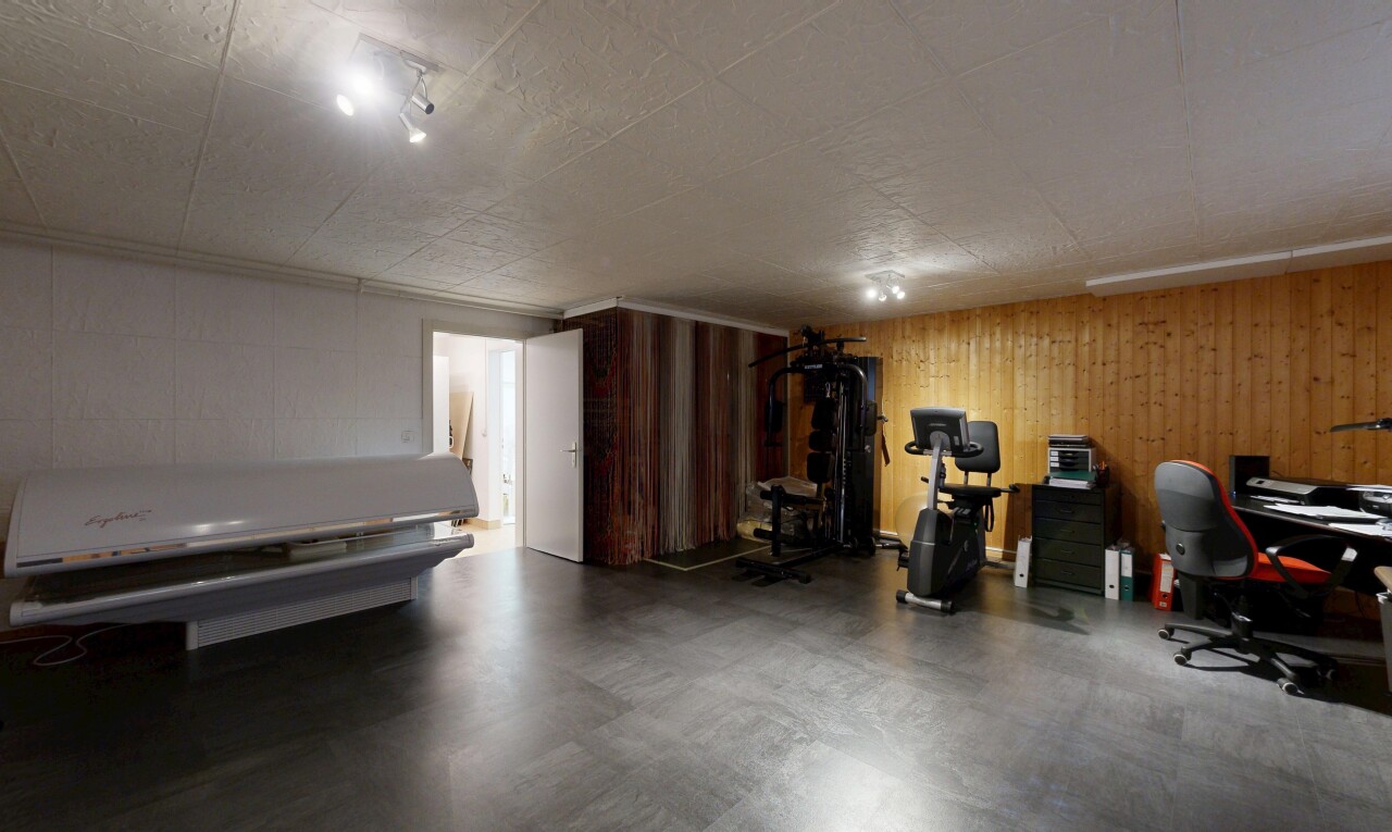 workout area featuring wood walls and concrete flooring