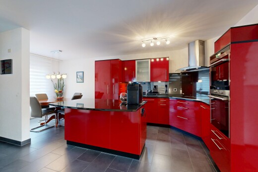 kitchen featuring red cabinets, range hood, and modern cabinets