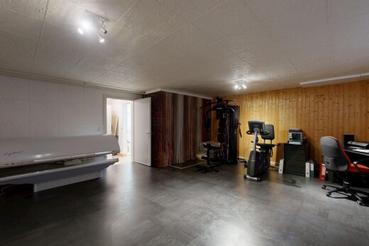 workout area featuring wood walls and concrete flooring