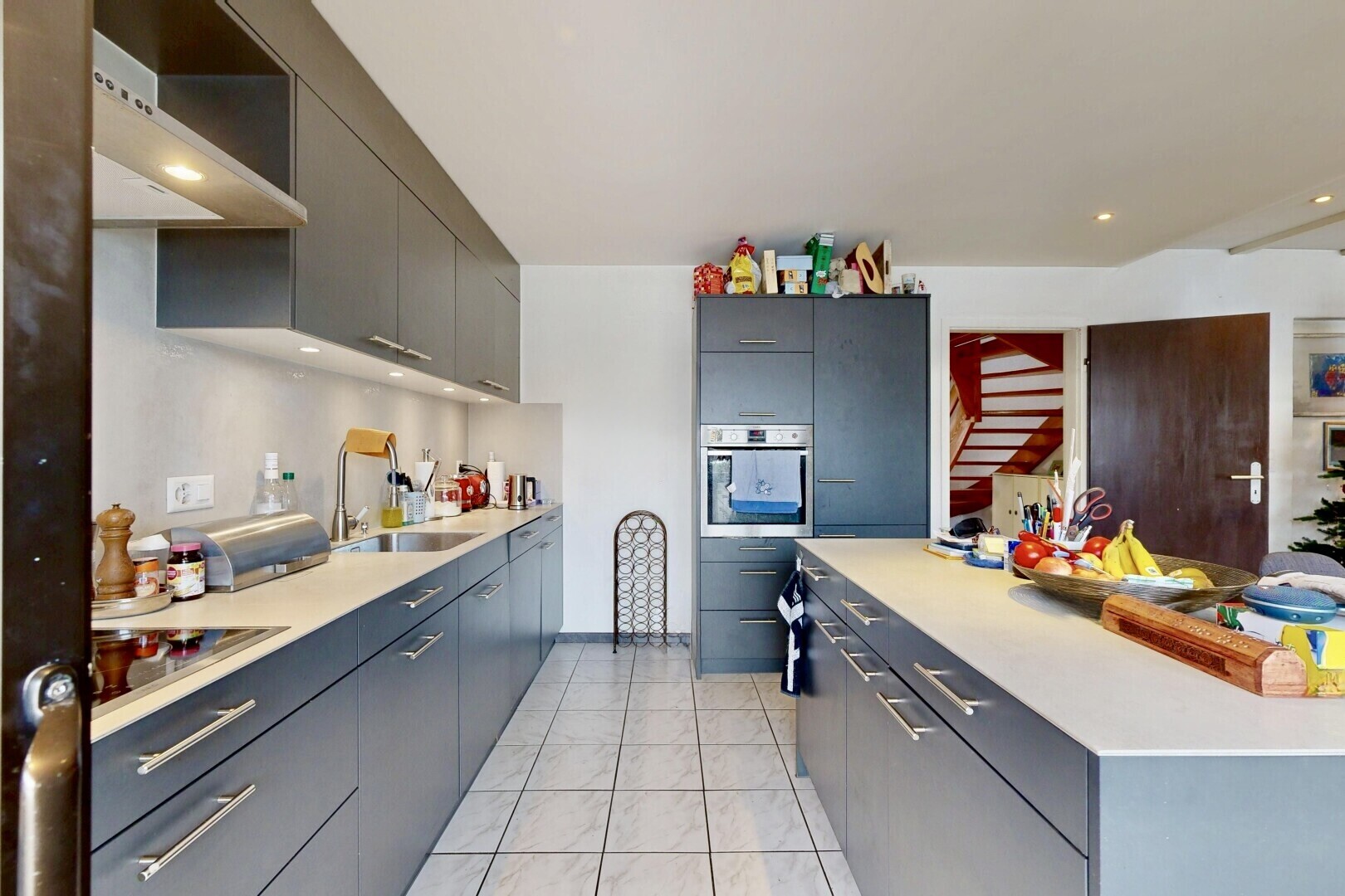 cuisine avec light floor, inside property, hotte, plans de travail, et light countertops