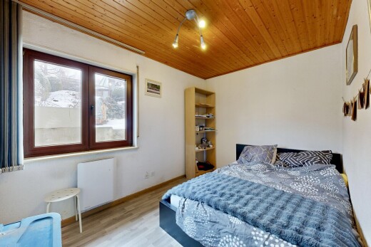 room / bedroom with wood finished floors, wooden ceiling, and radiator
