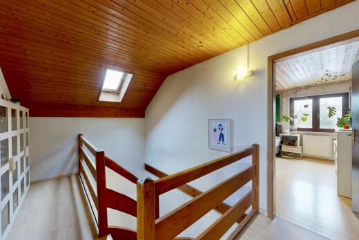 stairs featuring a skylight and wooden ceiling