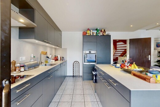 kitchen featuring light countertops, stainless steel oven, modern cabinets, recessed lighting, and gray cabinetry