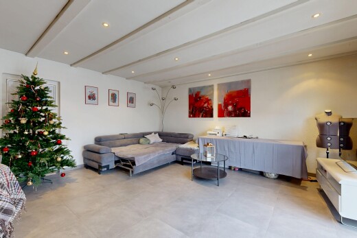 living area featuring beam ceiling, recessed lighting, and concrete flooring