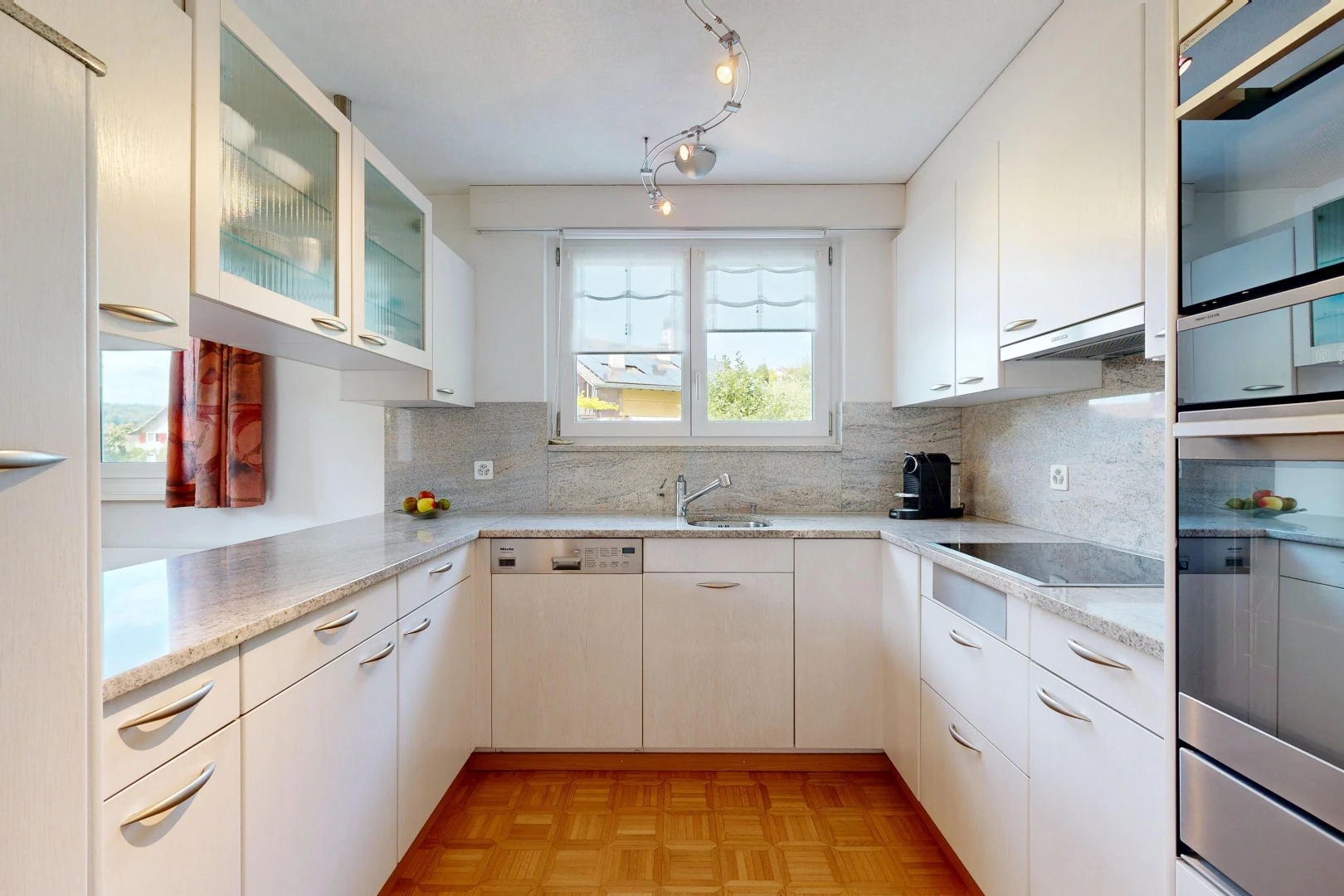 küche mit light countertops, glass insert cabinets, schränke mit glastüren, light floor, und parquet floor