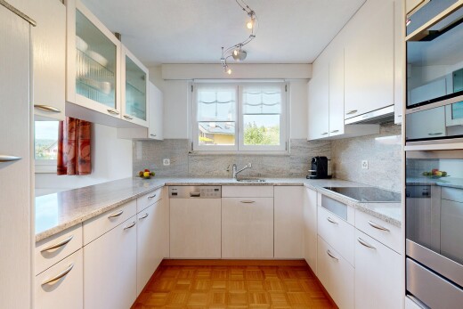 kitchen with glass fronted cabinets, parquet floors, white cabinets, and black appliances