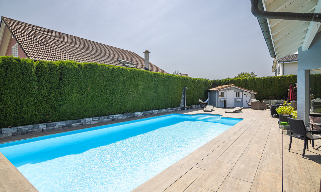 view of swimming pool featuring a patio area, a fenced backyard, and an outdoor structure